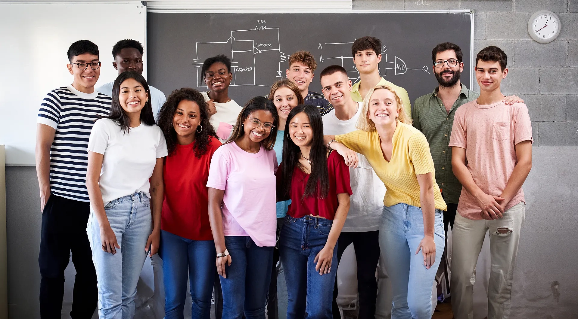 Diverse Studenten und Lehrer lächeln im Klassenzimmer.